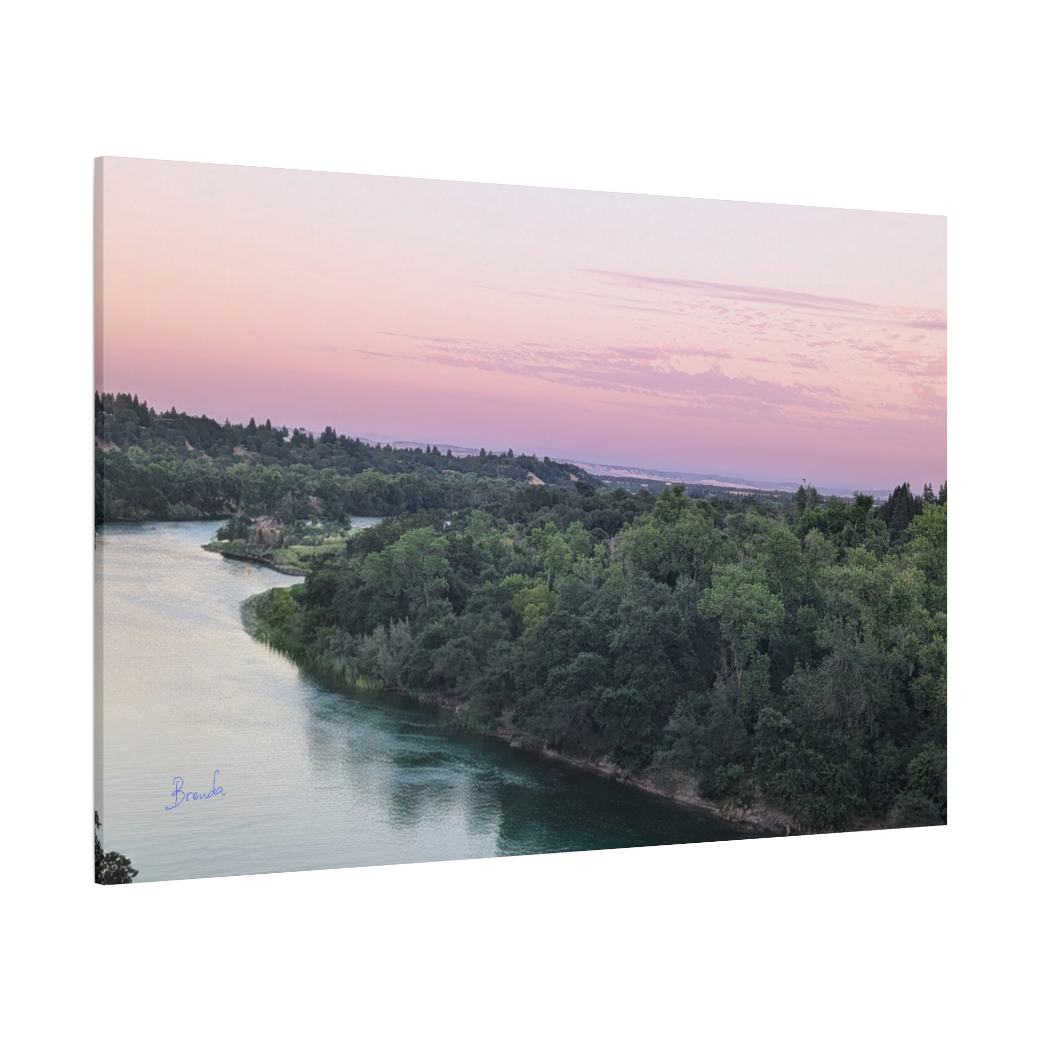 Fine art print of the Sacramento River at sunset, captured by Brenda Nakandi. Features tranquil afterglow skies in pink and gold tones, ideal wall decor for nature lovers and serene interior spaces